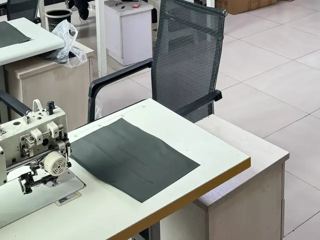 Fabric swatches and a backpack sample on the sampling table