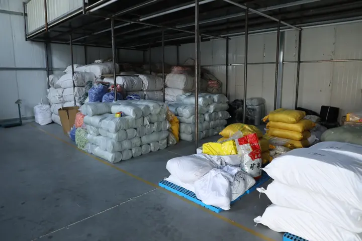 Colour-sorted stock backpacks staged for order picking